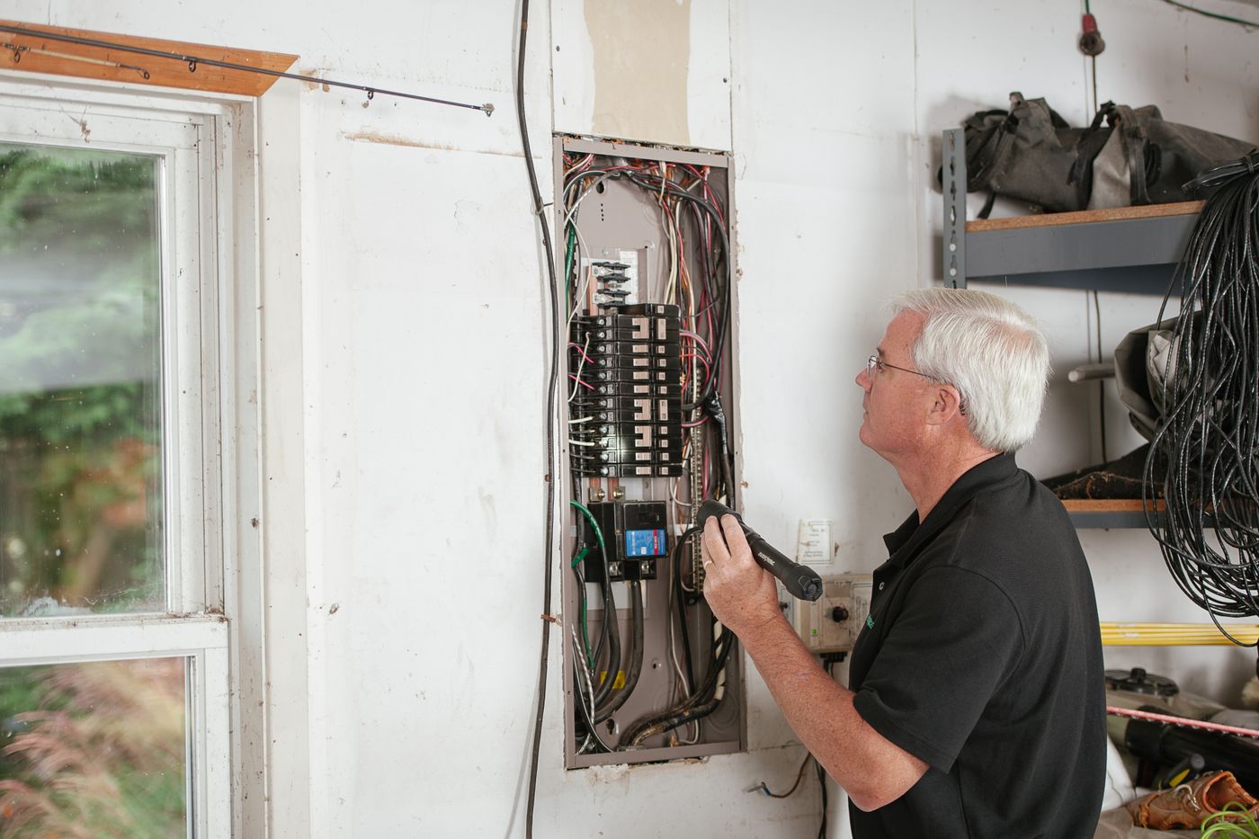 An electrician inspecting a residential switchboard